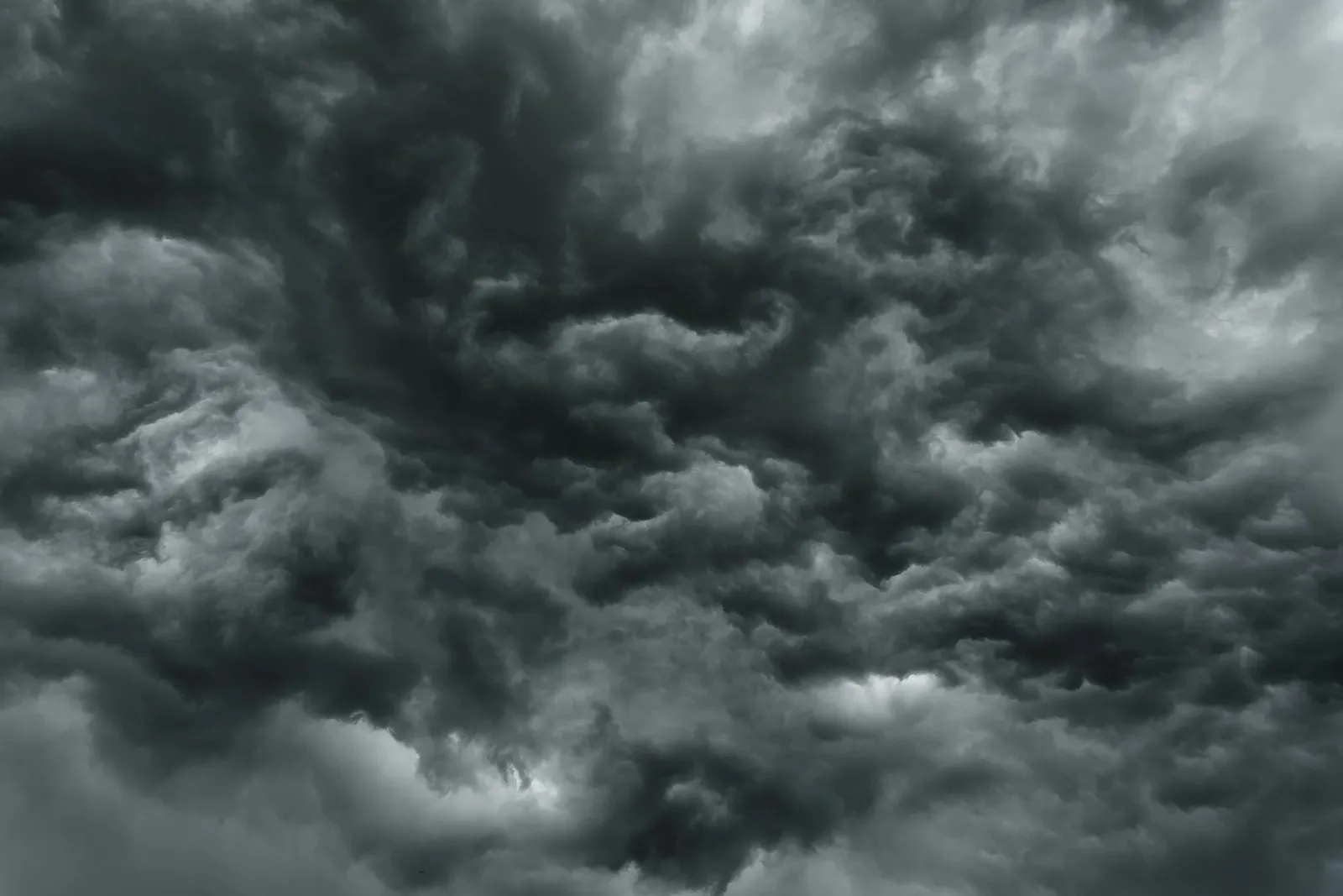Dense dark grey storm clouds swirling across the sky