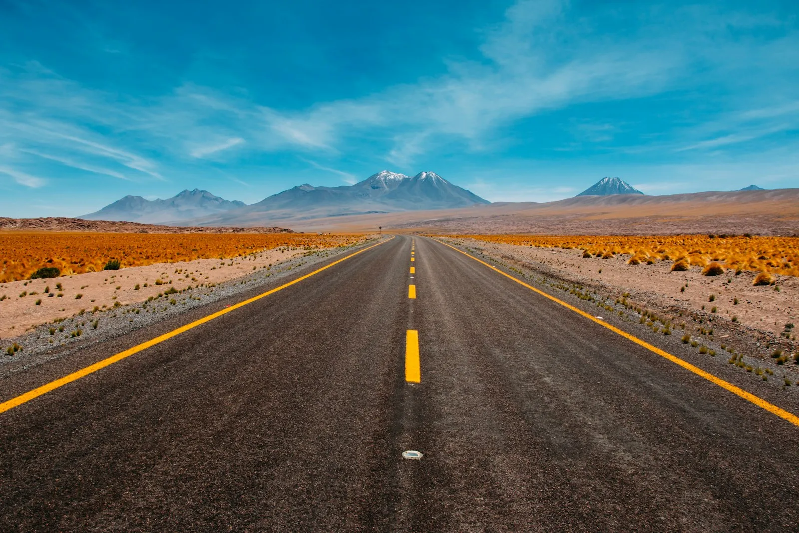 Lone road going to mountains