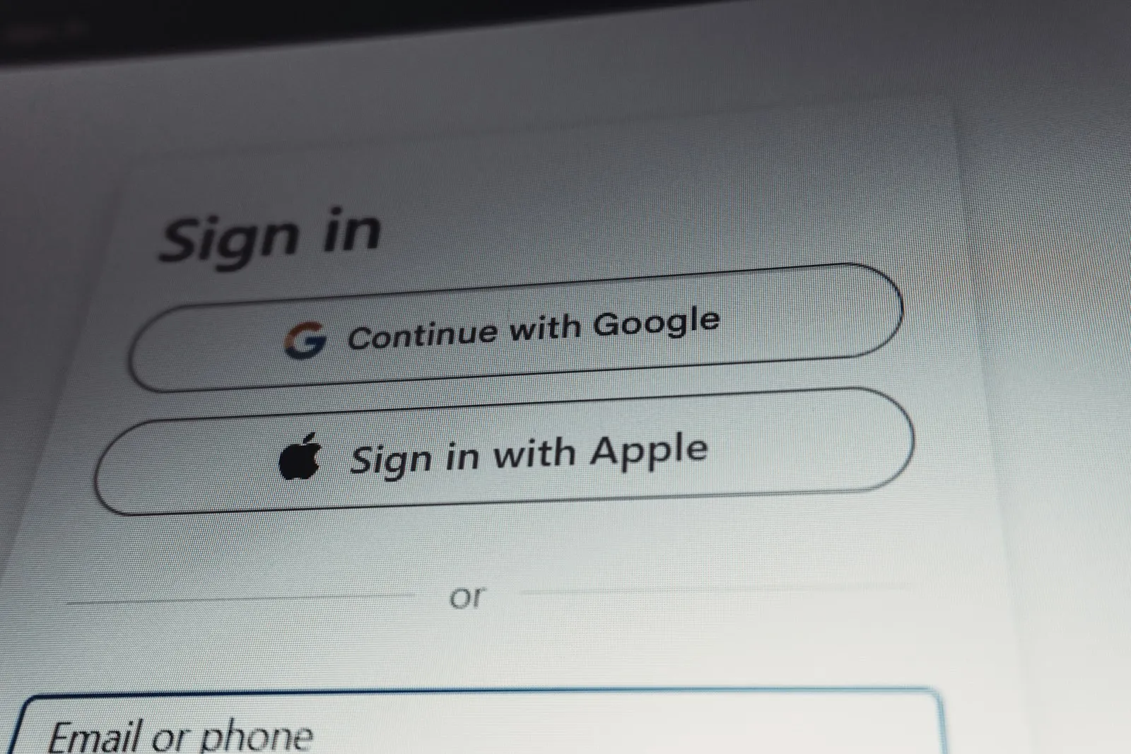 A sign in screen with Continue with Google and Sign in with Apple buttons above an email field