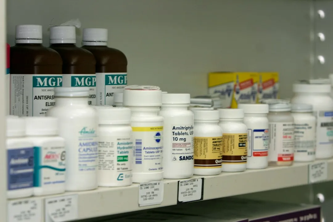 A pharmacy shelf filled with rows of different medicine boxes and bottles
