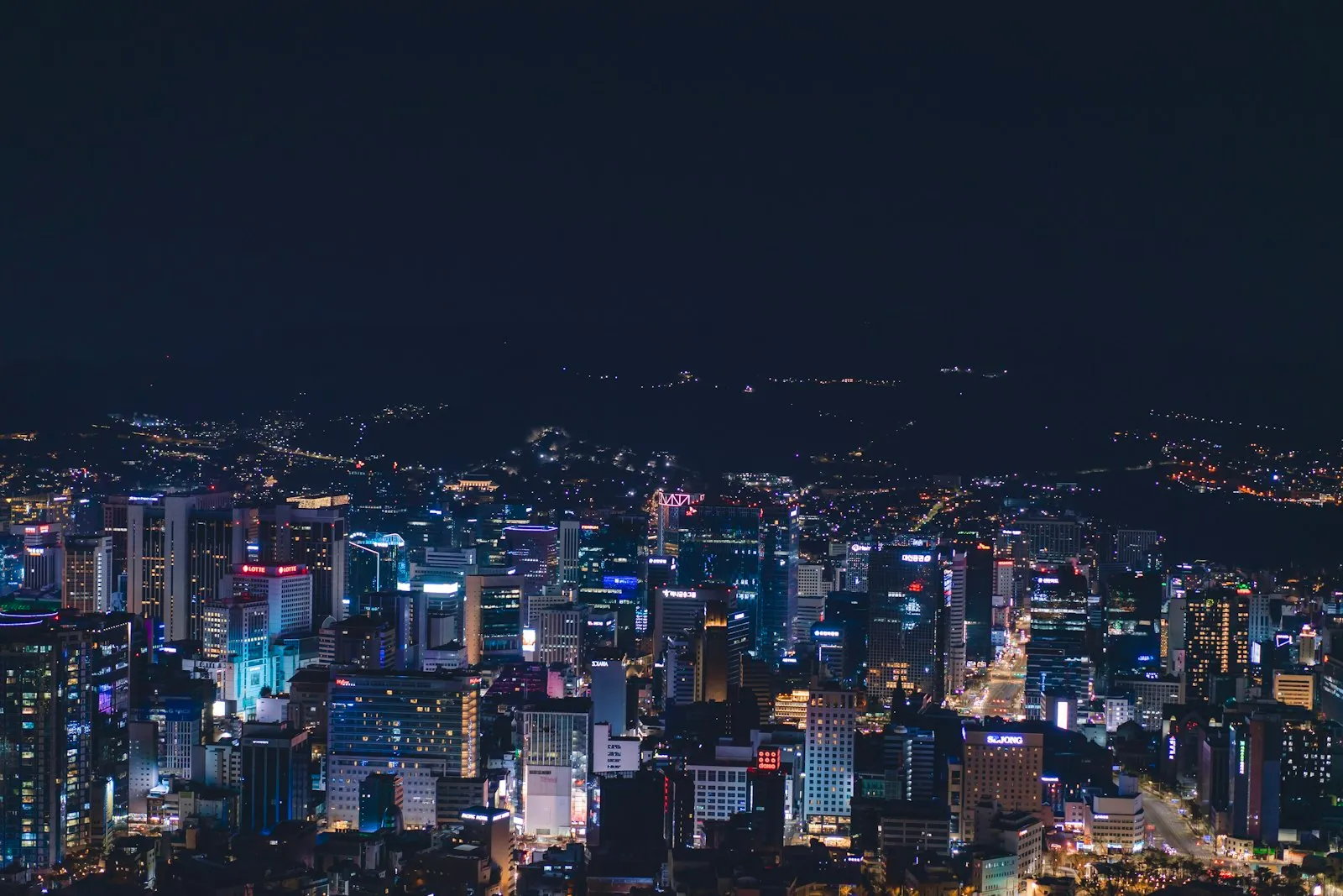 Night view of a city with many tall lit buildings