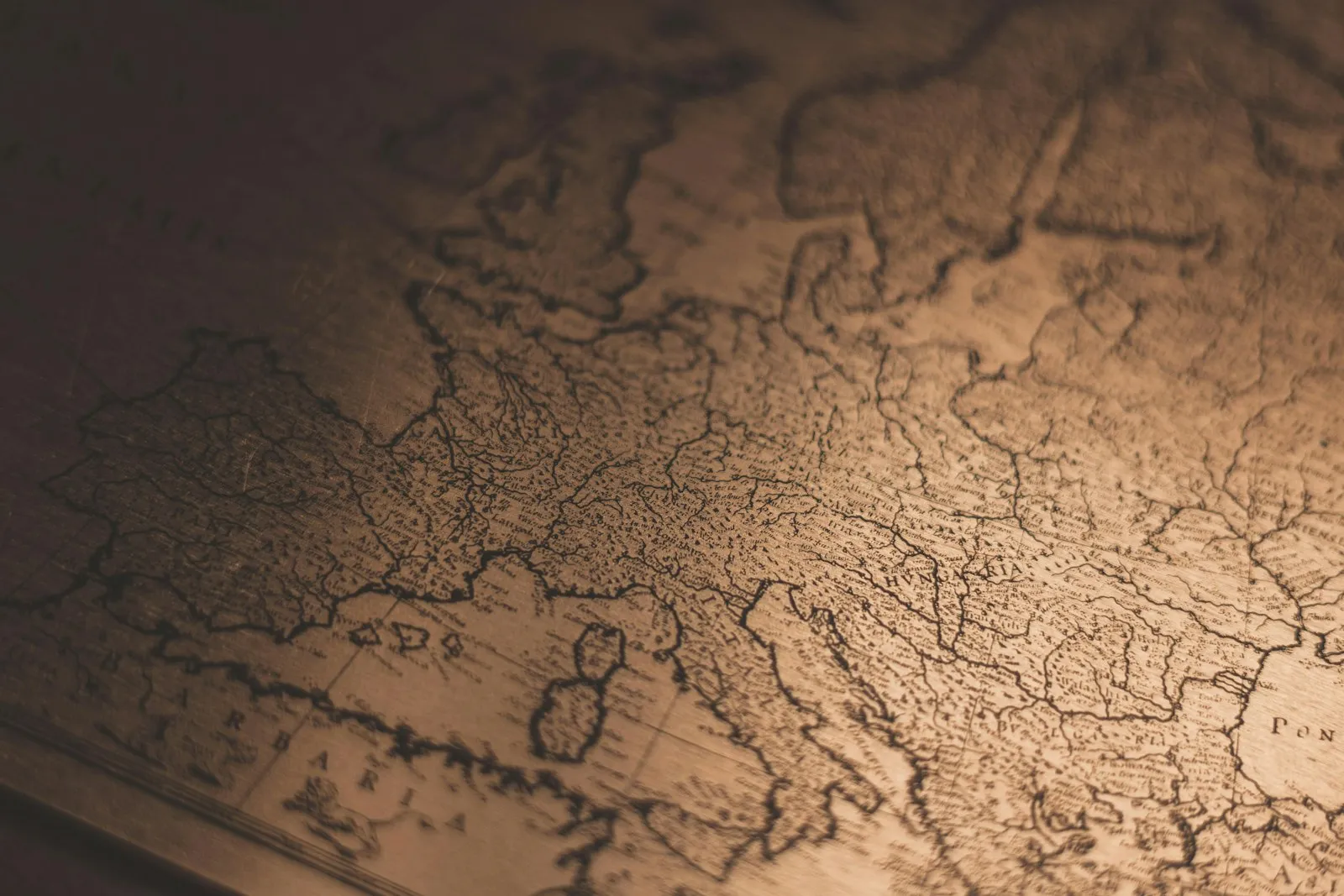 Close-up of an antique map of Europe lit by warm side light
