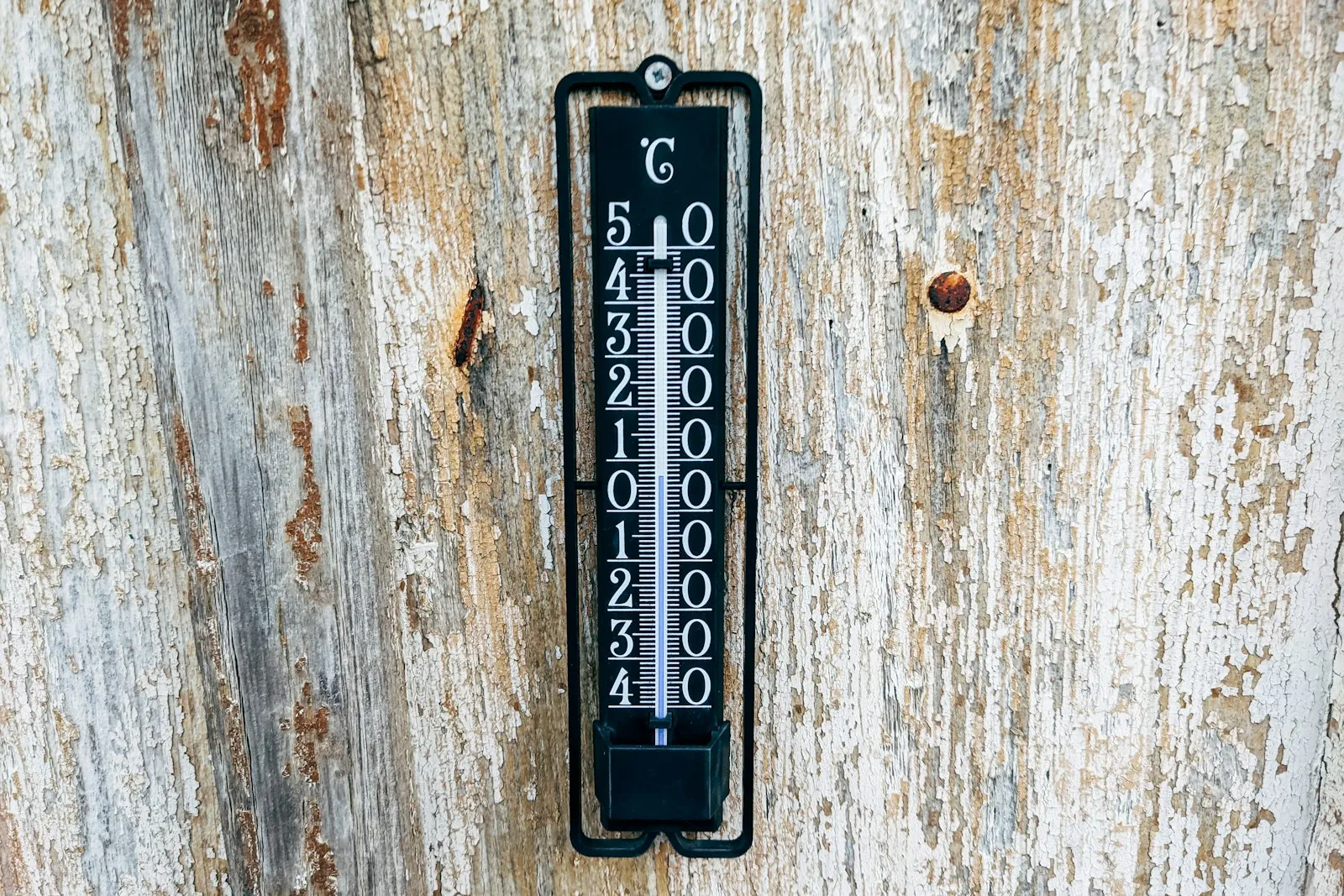 A door handle on a wooden door marked with numbers