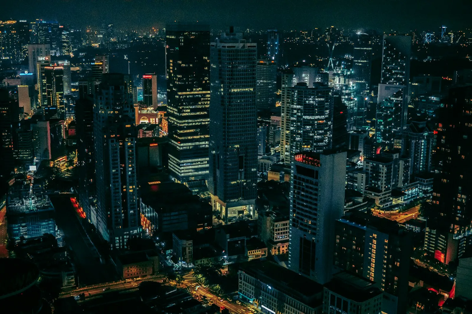 Aerial view of a dense city of lit high-rise buildings at night