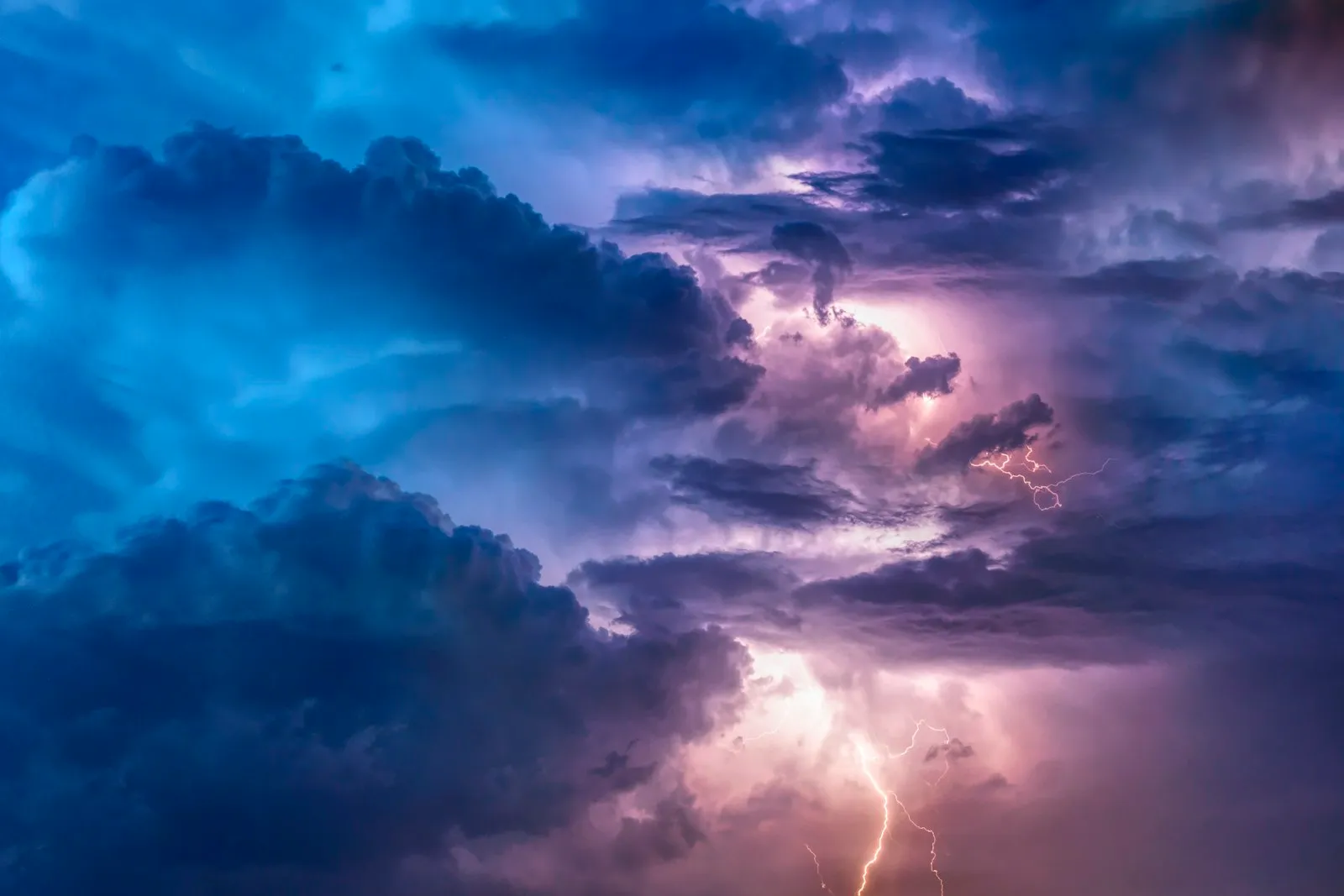 Storm clouds lit up by lightning